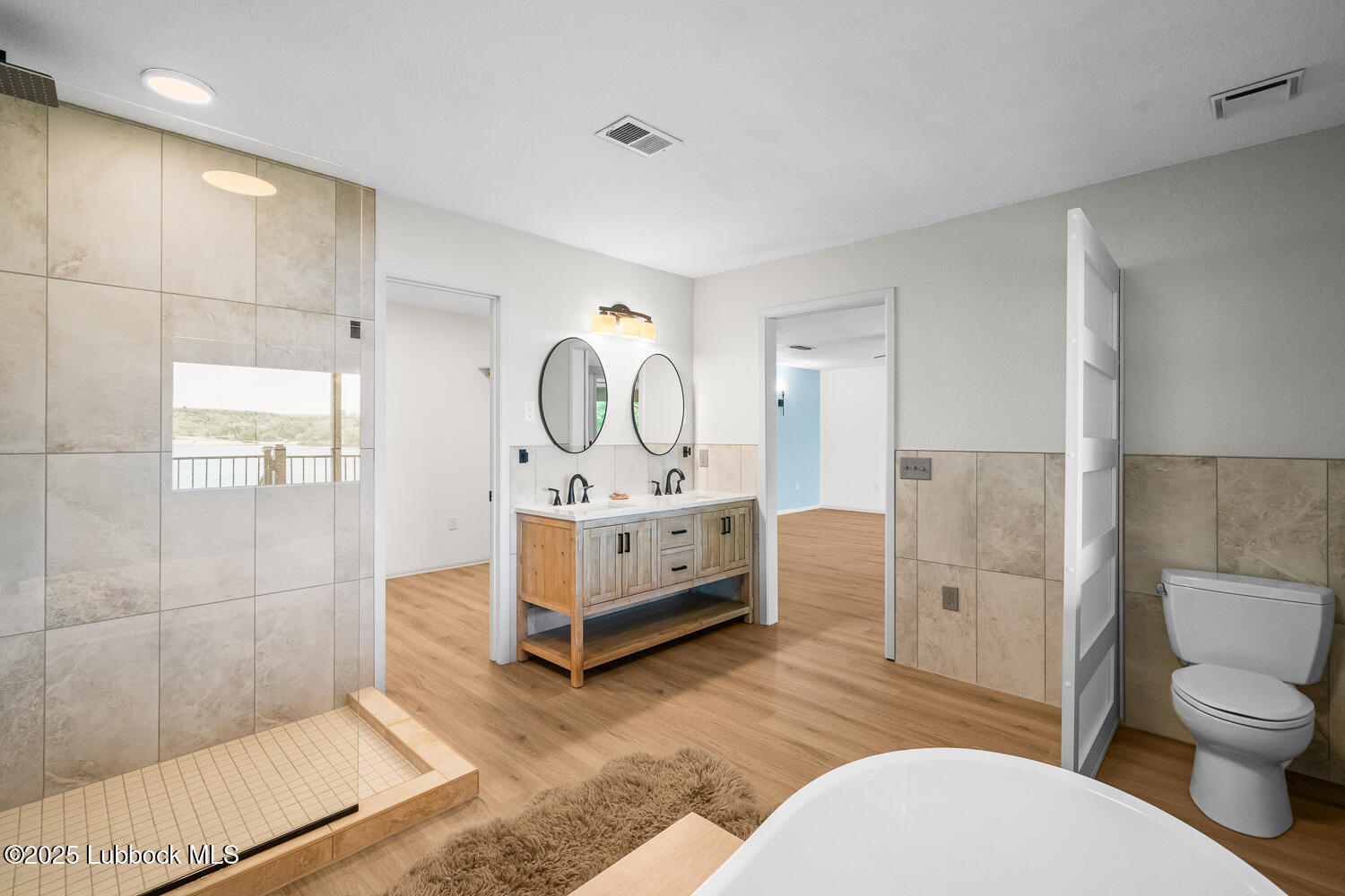 146 Pony Express Trail Buffalo Springs, TX 79404 - Photo 14 of 48 a bathroom with a sink a toilet and shower