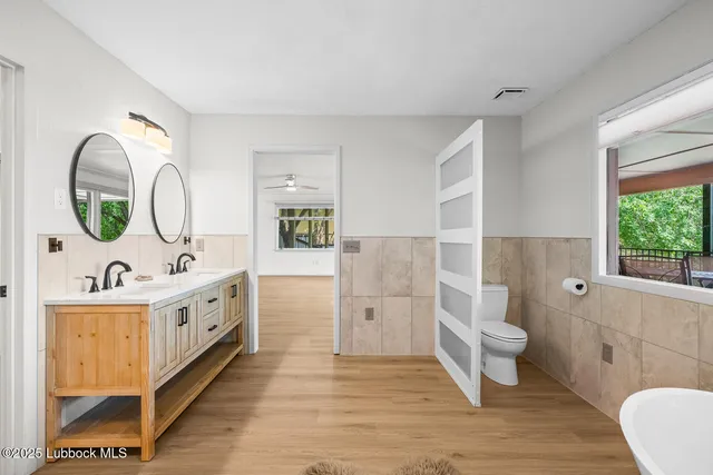 a bathroom with a sink a mirror and a window