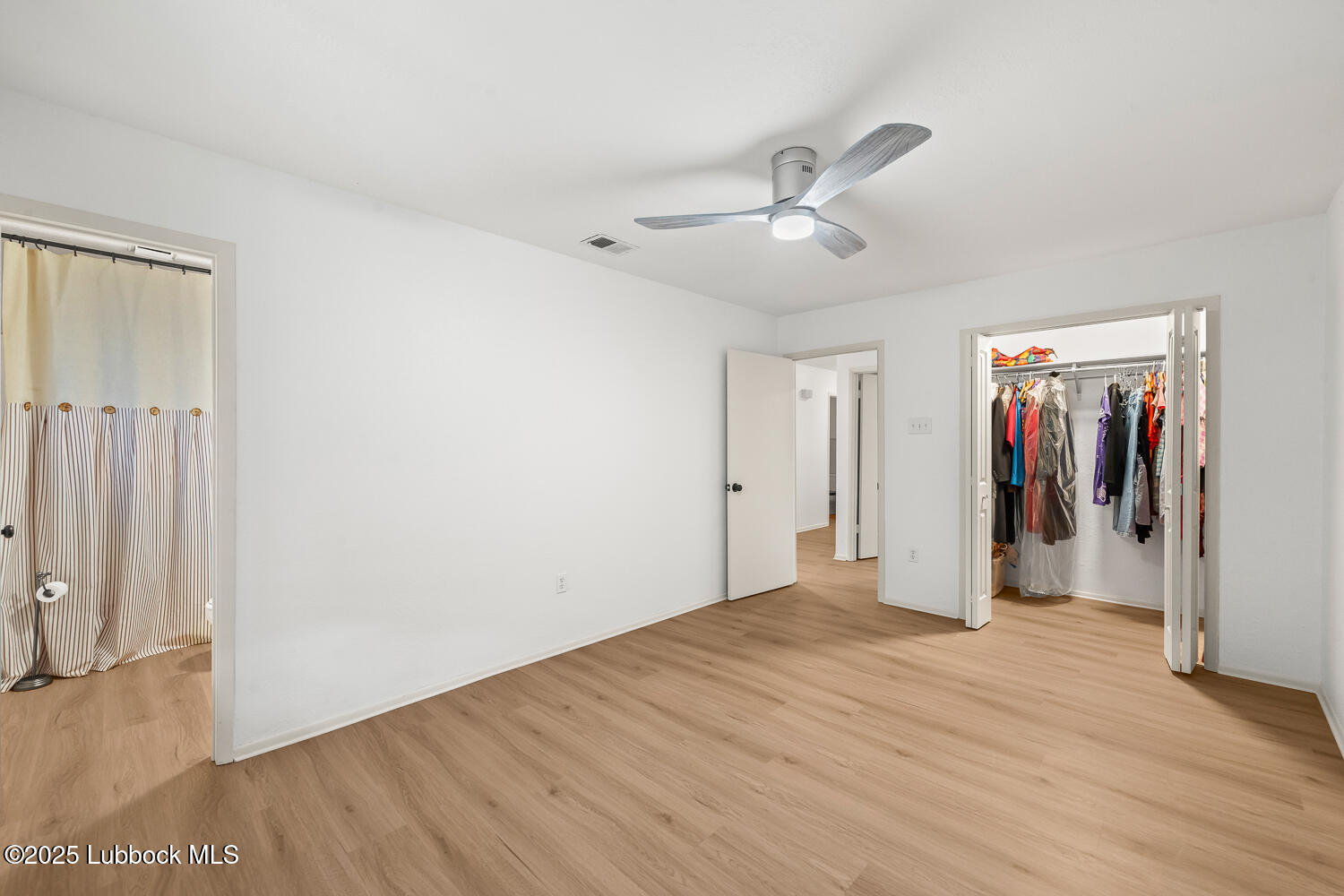 146 Pony Express Trail Buffalo Springs, TX 79404 - Photo 19 of 48 a view of empty room with wooden floor