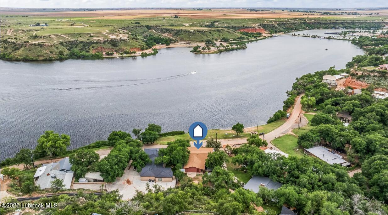146 Pony Express Trail Buffalo Springs, TX 79404 - Photo 2 of 48 an aerial view of lake and residential houses with outdoor space