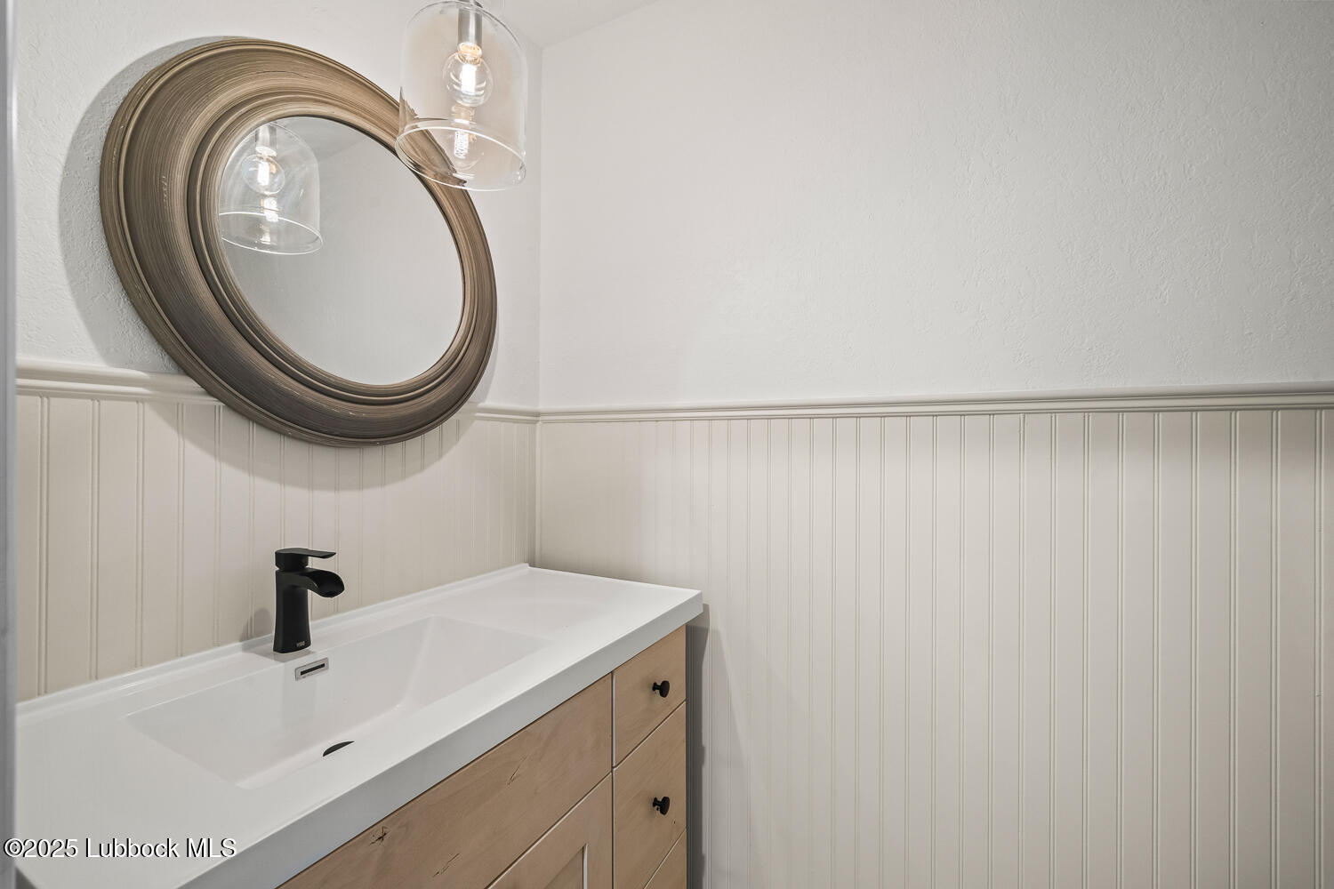 146 Pony Express Trail Buffalo Springs, TX 79404 - Photo 22 of 48 a bathroom with a sink and a mirror
