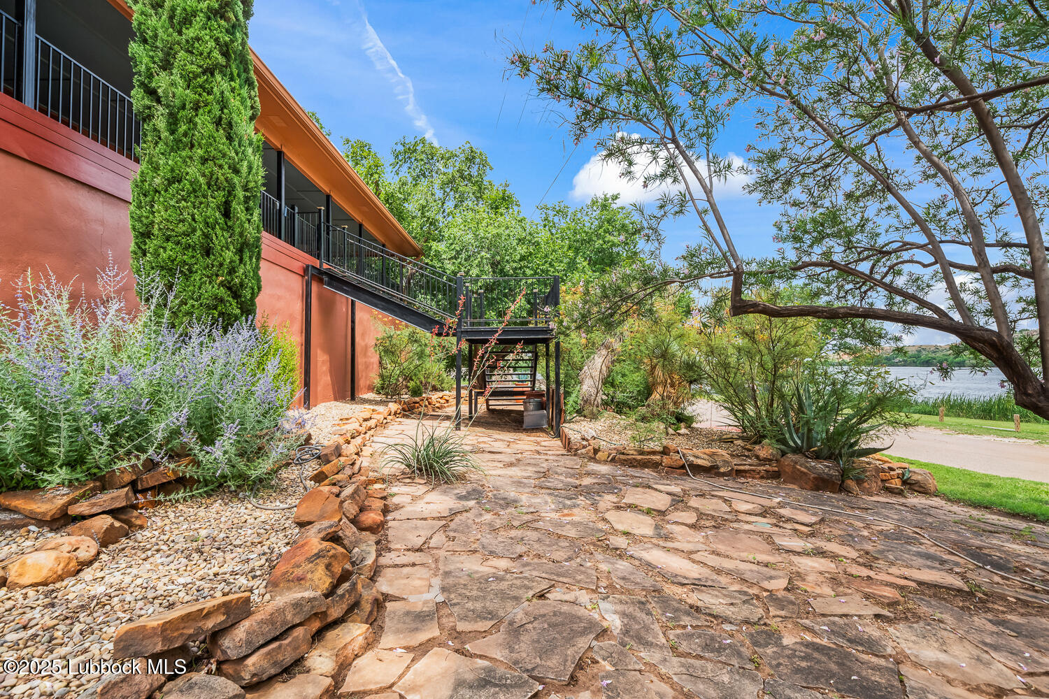 146 Pony Express Trail Buffalo Springs, TX 79404 - Photo 35 of 48 a view of a backyard with plants and large trees