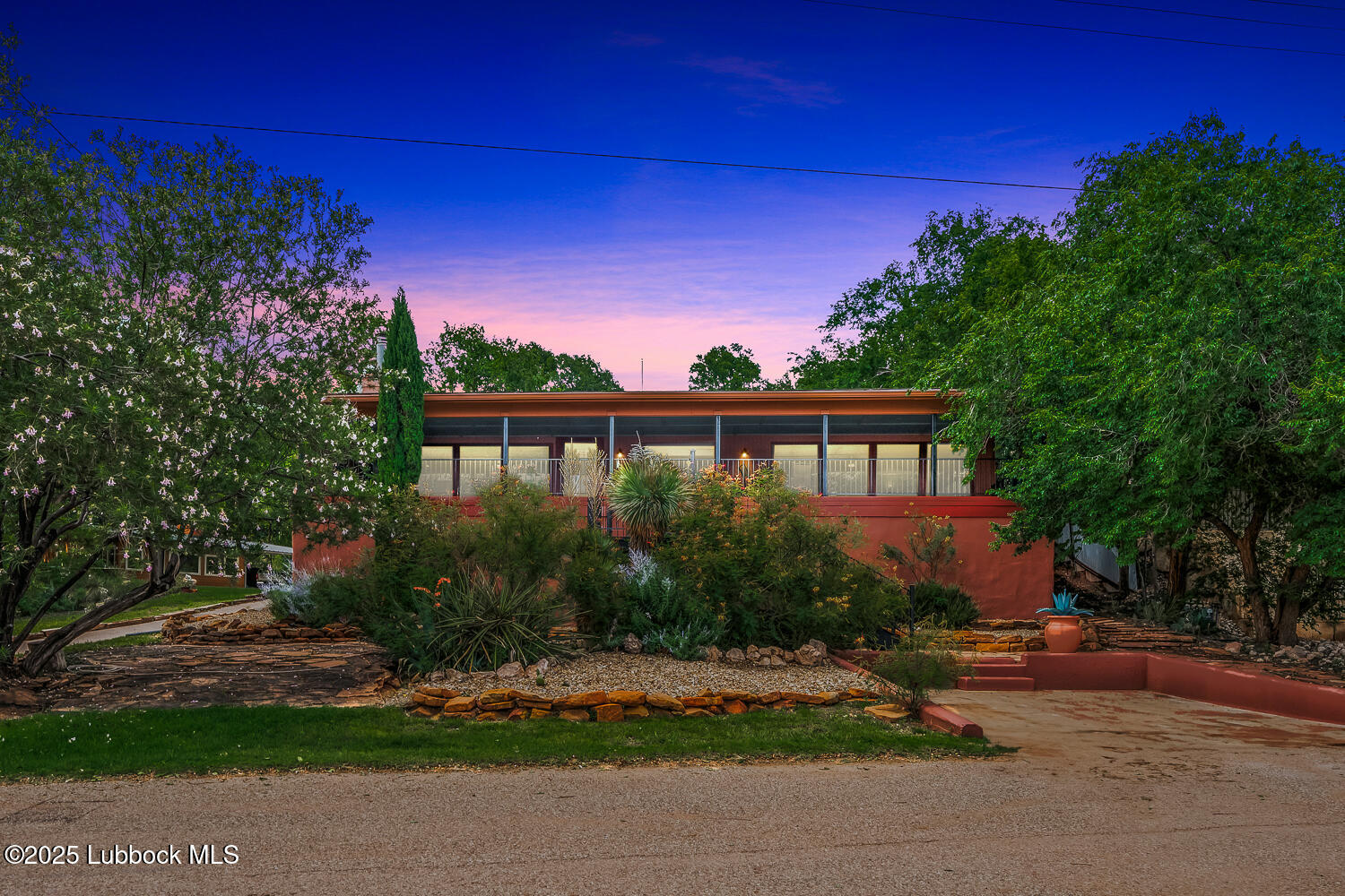 146 Pony Express Trail Buffalo Springs, TX 79404 - Photo 45 of 48 a front view of a house with a yard and potted plants