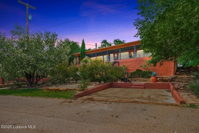 a front view of a house with a yard and a street