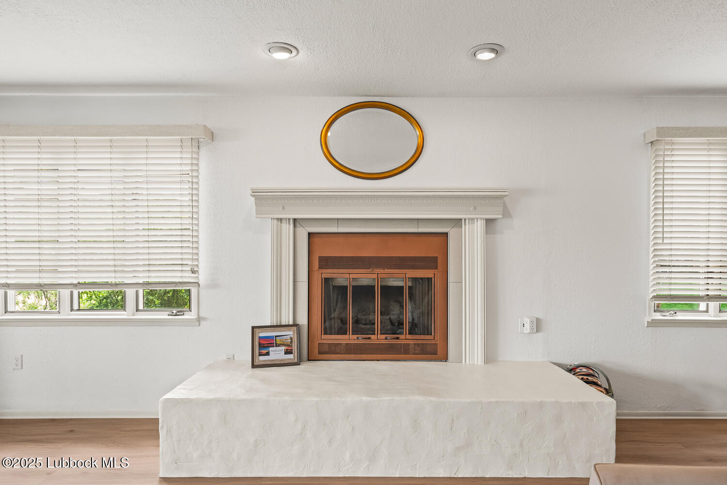 146 Pony Express Trail Buffalo Springs, TX 79404 - Photo 7 of 48 a living room with a fireplace and a large window