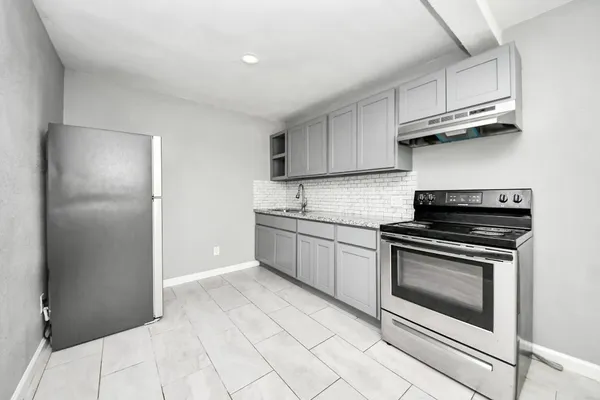 a kitchen with stainless steel appliances granite countertop a stove and a refrigerator
