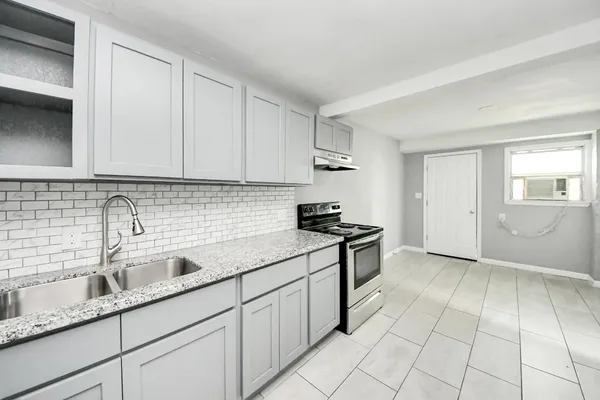 a kitchen with a sink and cabinets