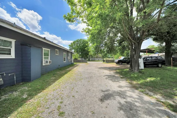 a view of a backyard with a garden and parking