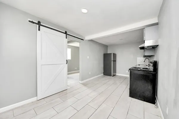 a kitchen with stainless steel appliances granite countertop a refrigerator and a stove