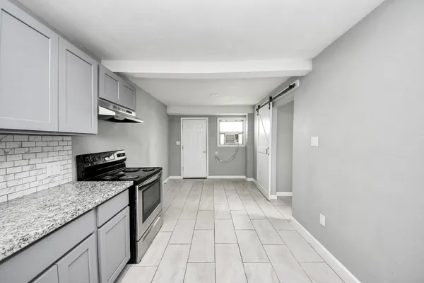 a kitchen with stainless steel appliances granite countertop a sink stove and cabinets