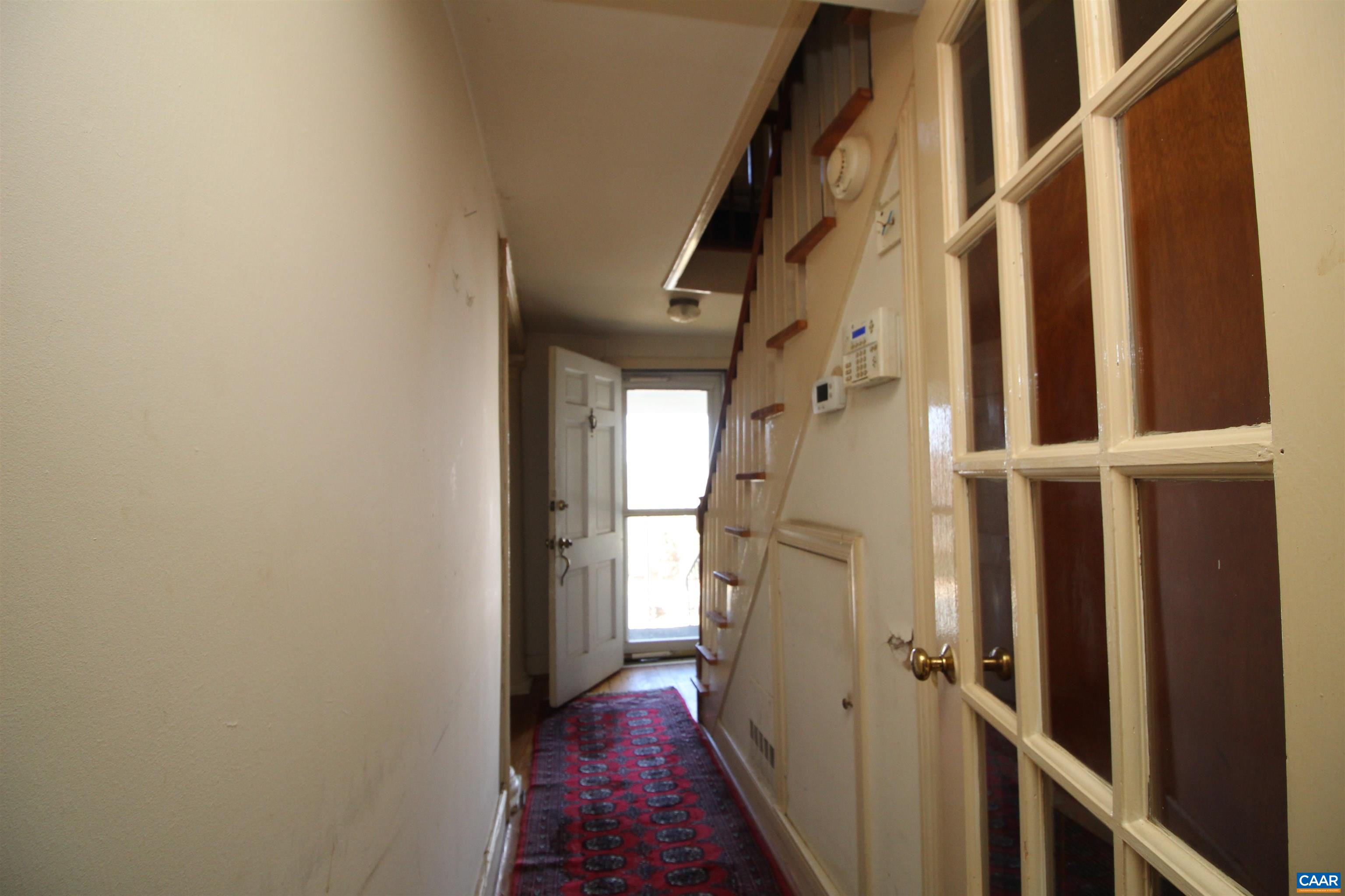 884 Ridge Street Charlottesville, VA 22902 - Photo 8 of 13 a view of a hallway with wooden floor and staircase