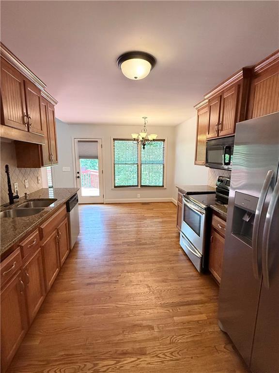 102 Oak Ridge Trail White, GA 30184 - Photo 14 of 37 a kitchen with stainless steel appliances granite countertop a stove a sink dishwasher and a microwave oven with white cabinets