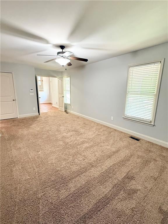 102 Oak Ridge Trail White, GA 30184 - Photo 24 of 37 an empty room with windows and ceiling fan