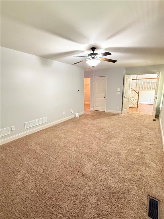 102 Oak Ridge Trail White, GA 30184 - Photo 32 of 37 an empty room with chandelier fan and windows