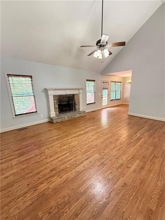 102 Oak Ridge Trail White, GA 30184 - Photo 9 of 37 an empty room with wooden floor chandelier fan and windows