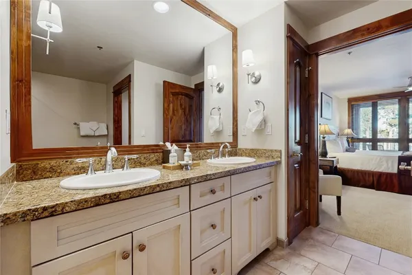 a bathroom with a granite countertop bathtub shower and sink