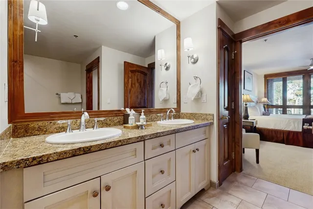 a bathroom with a granite countertop bathtub shower and sink