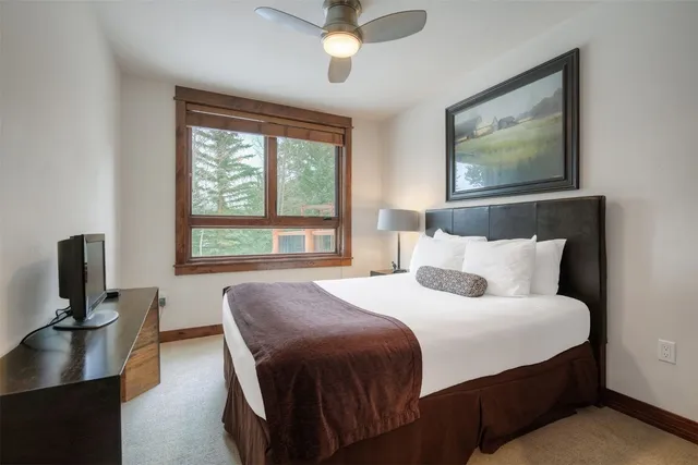 a bedroom with furniture and flat screen tv