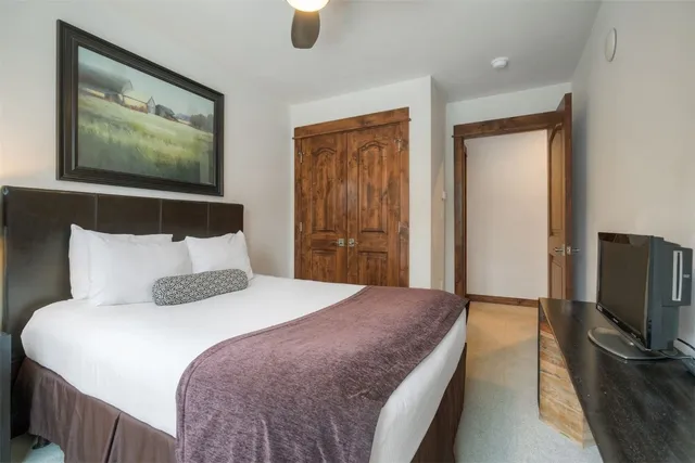 a bedroom with a bed and a cabinet