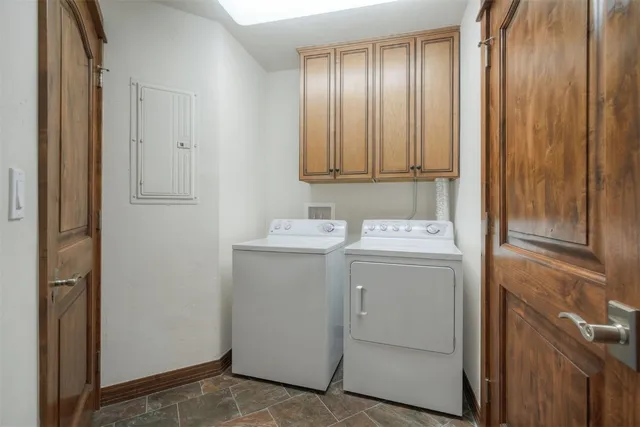a living room with furniture a fireplace and a chandelier