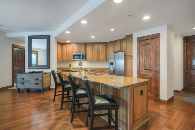 a bedroom with a large bed and a flat tv screen on dresser