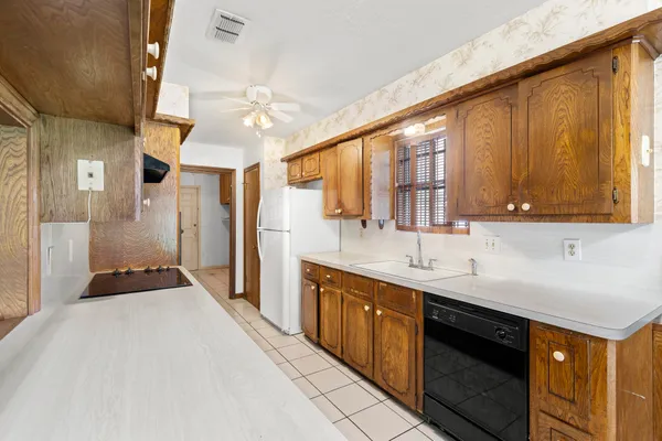 a kitchen with a sink stove and cabinets