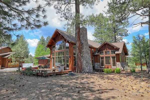 a view of a house with a yard and tree s