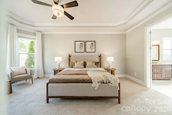 a spacious bedroom with a bed couch and a window