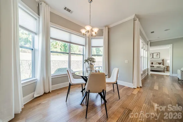 a view of a dining room with furniture window and wooden floor