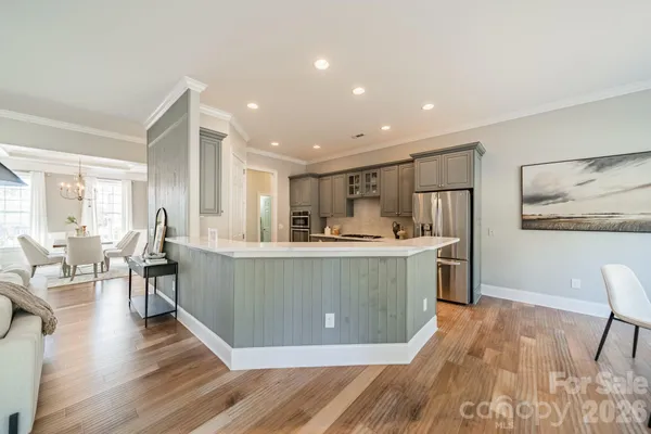 a living room with furniture a wooden floor and a sink