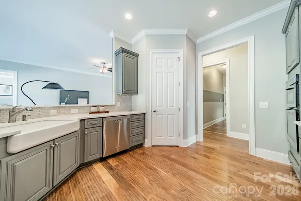 a spacious bathroom with a double vanity sink a mirror and a shower