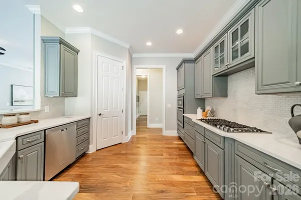 a kitchen with stainless steel appliances a sink and cabinets