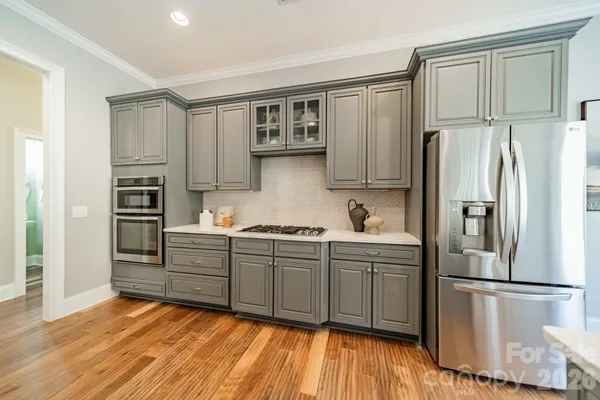 a kitchen with stainless steel appliances granite countertop a refrigerator sink and cabinets