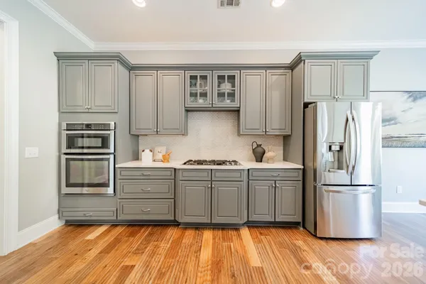 a kitchen with granite countertop a refrigerator and a sink