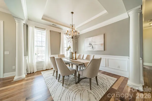 a view of a dining room with furniture window and wooden floor