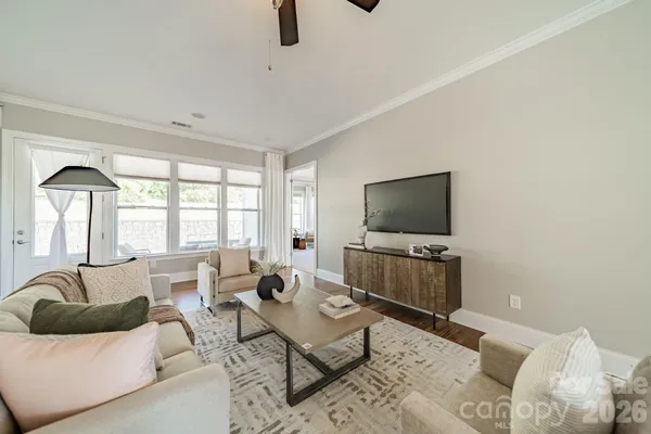 a living room with furniture and a flat screen tv