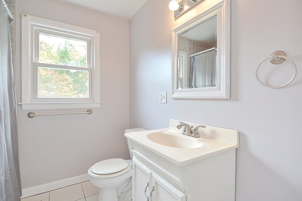 151 Baldwin Road, Unit 151 Billerica, MA 01821 - Photo 11 of 22 a bathroom with a sink toilet and a mirror