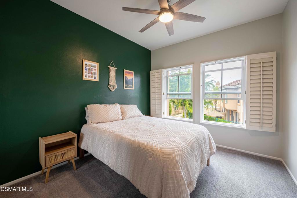 580 Fenwick Way, Unit C Simi Valley, CA 93065 - Photo 28 of 39 a bedroom with a bed and a window