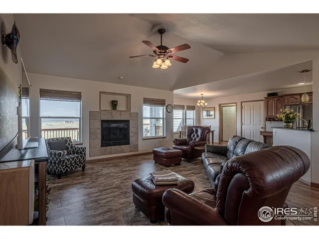 a living room with furniture a fireplace and wooden floor