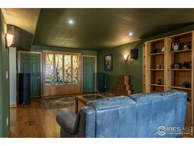 a living room with hard wood floors and a large bed
