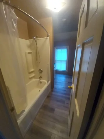 a bathroom with a bathtub and a shower