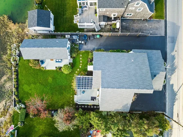 a room with granite countertop wooden cabinets and refrigerator