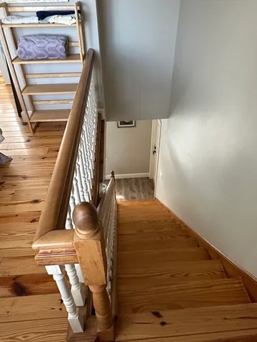 a bedroom with furniture and wooden floor