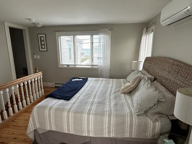 a bedroom with a bed and a large window