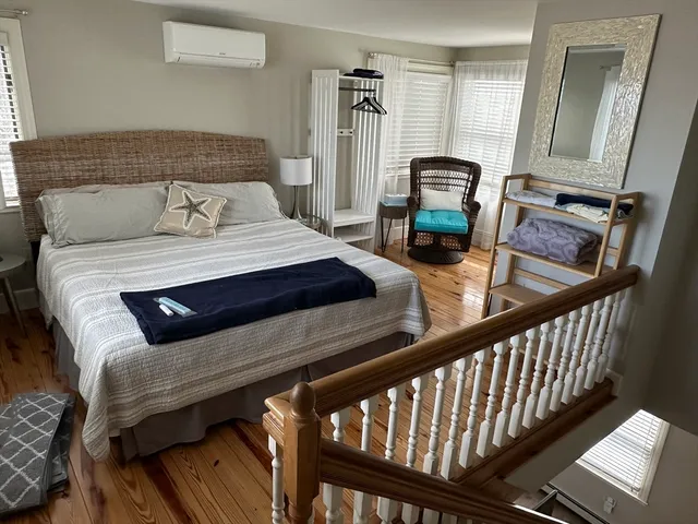 a bedroom with bed and a window