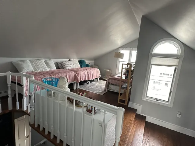 a bedroom with a bed next to a window