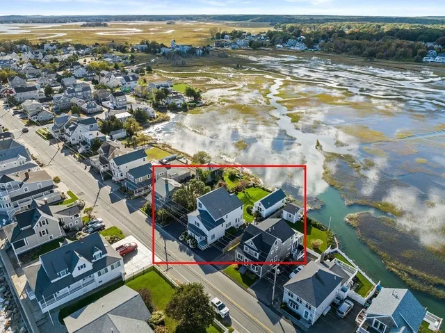 an aerial view of a house with a ocean view