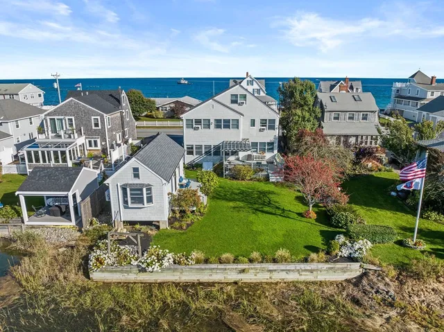 an aerial view of a house with garden space and street view