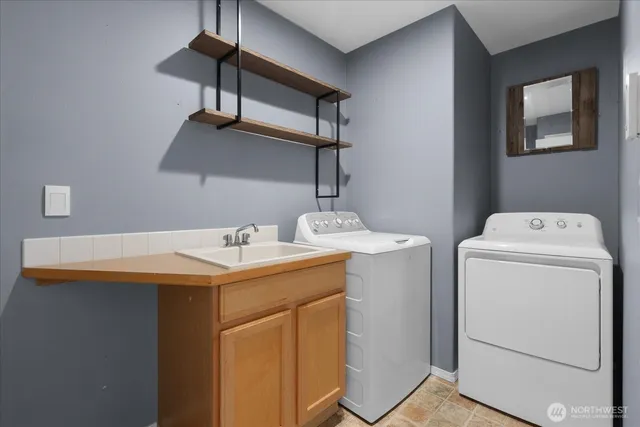 a spacious bedroom with a bed and a chandelier