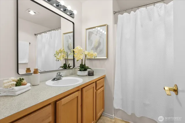 an aerial view of residential houses with outdoor space and lake view